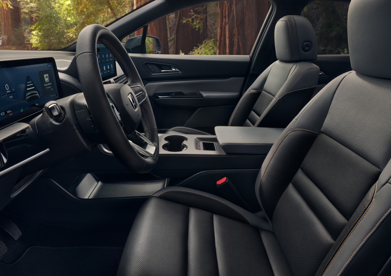 Interior view of the 2026 Honda Prologue showing black leather-trimmed front seats, digital driver display, center touchscreen, and modern EV cabin design.