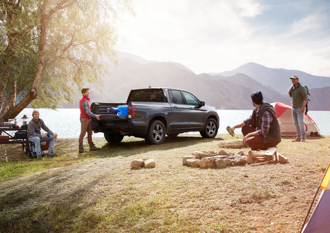 2025 Honda Ridgeline At a camp site with four men setting up and truck bed being unloaded