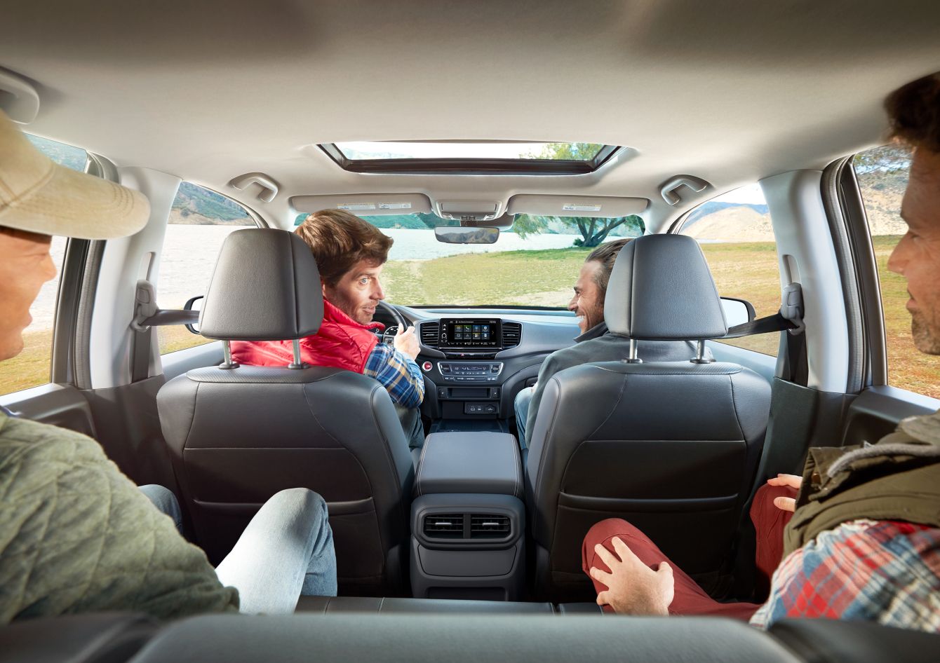 2026 Honda Ridgeline with four passengers, driver looking back