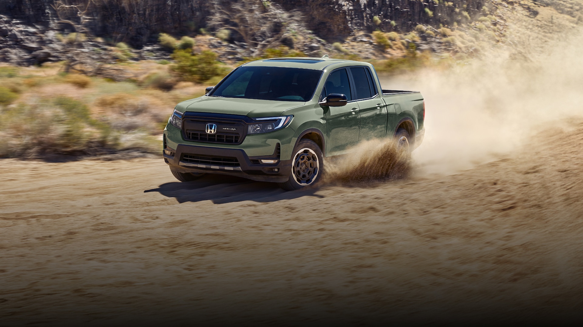 2026 Honda Ridgeline Trailsport in green offroading through the dirt