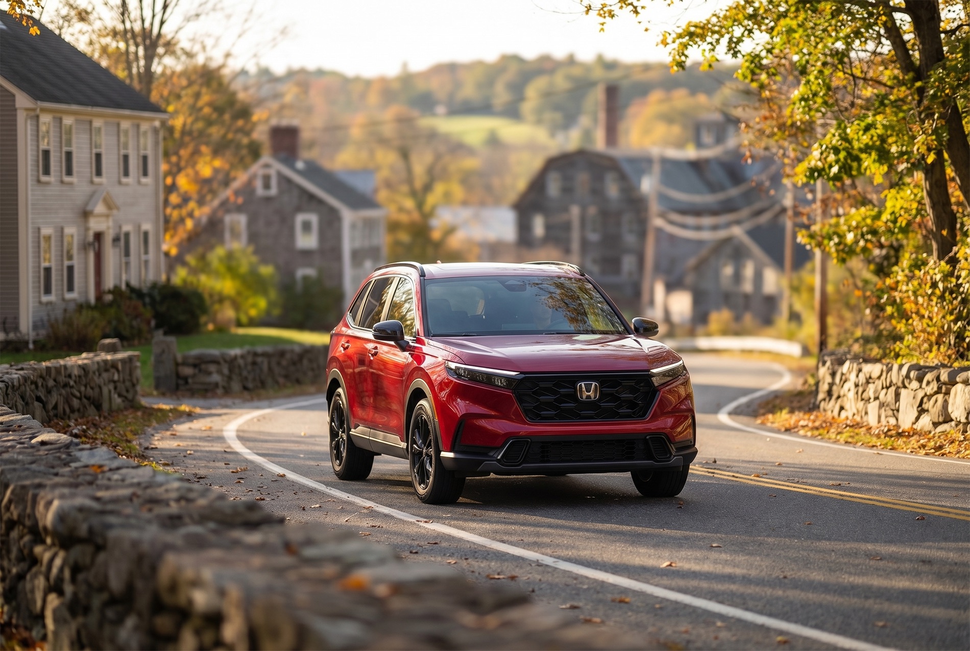 2026 Honda CR-V Sport-L Hybrid trim level driving through a small New England town