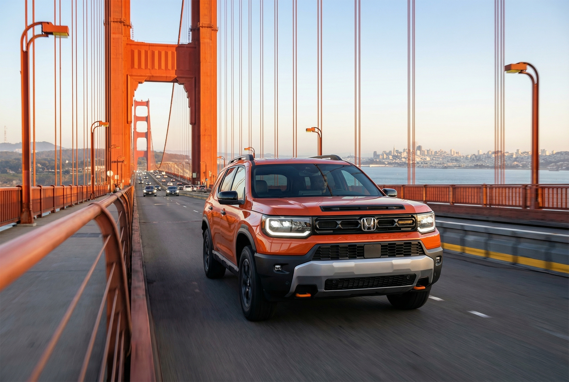 2026 Honda Passport Elite driving across the Golden Gate Bridge in San Francisco on a clear day.