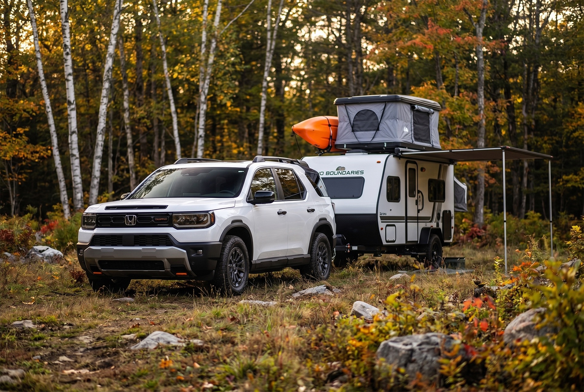 2026 Passport TrailSport trim level parked in front of an off road trailer camper in the woods