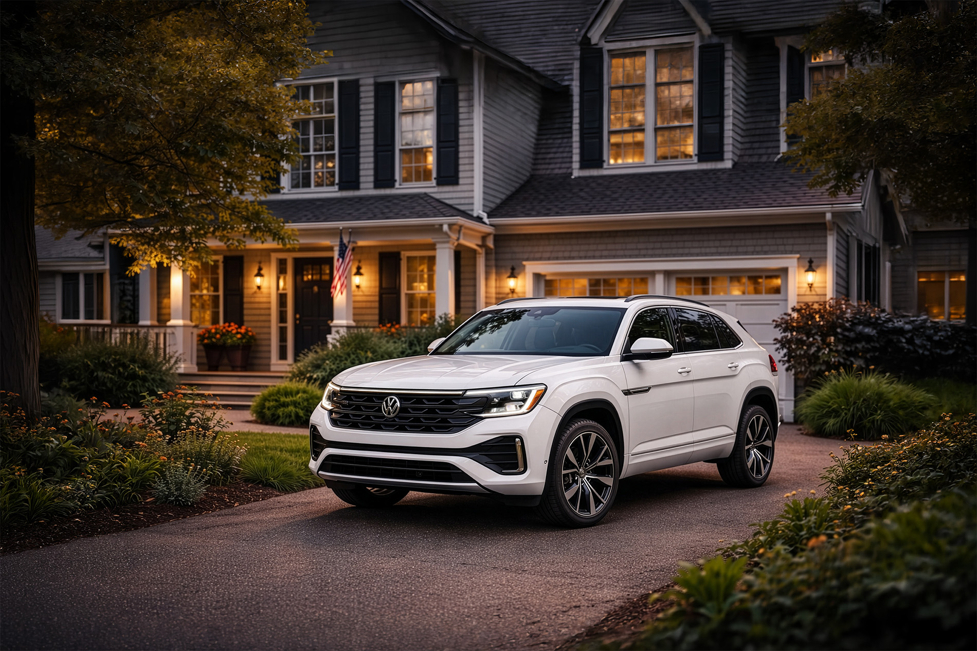 2026 Volkswagen Atlas Cross Sport parked in the driveway of a two story victorian home in the evening
