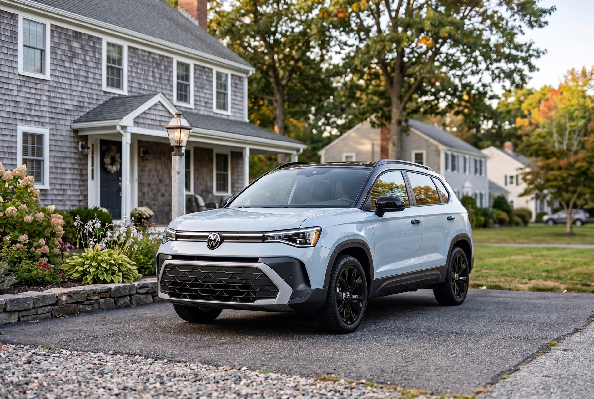 2026 Volkswagen Taos SE Black Trim Level parked in the driveway of a two story home in Easton MA