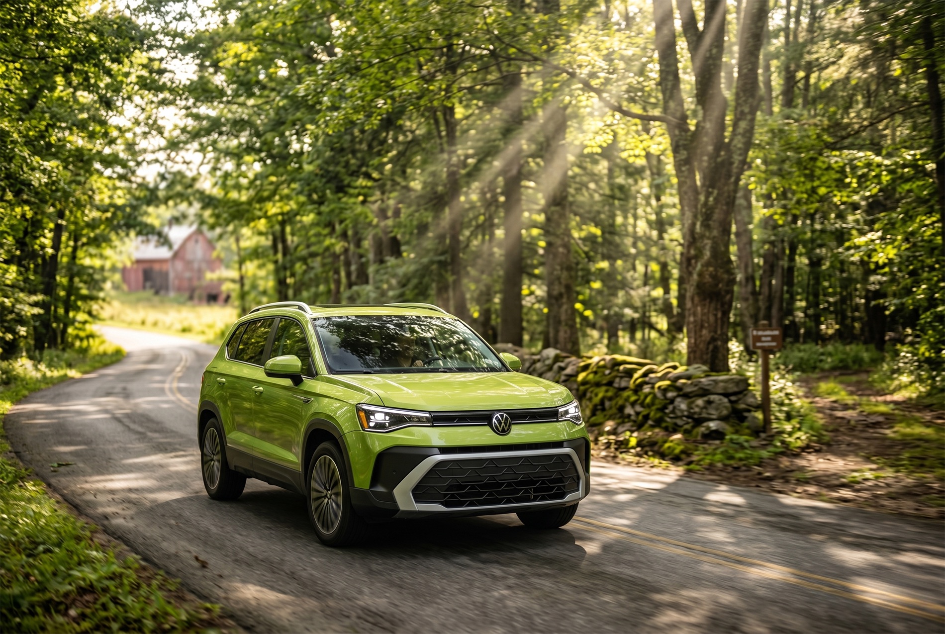 2026 Volkswagen Taos SE Trim Level driving through the New England woods on an old road