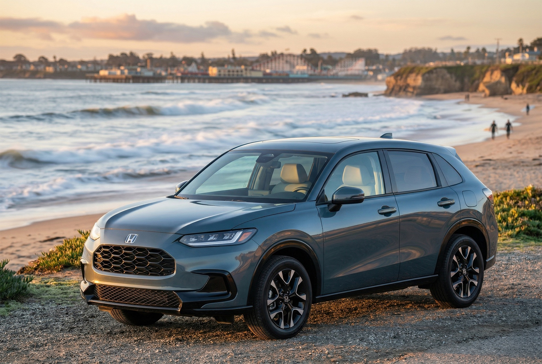 2027 Honda HR‑V parked on the sand near the shoreline at Santa Cruz Beach, with ocean waves and warm coastal light creating a relaxed, scenic backdrop.