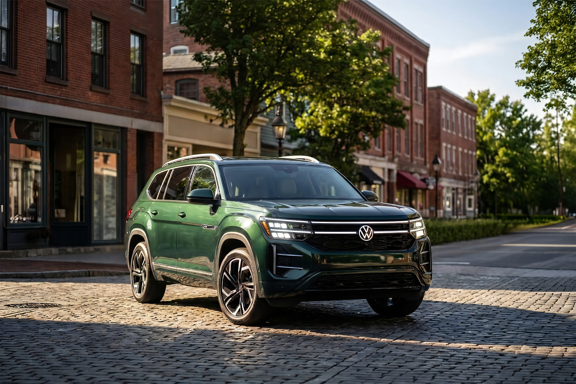 2027 Volkswagen Atlas parked an old downtown part of a city with brick buildings and roadway