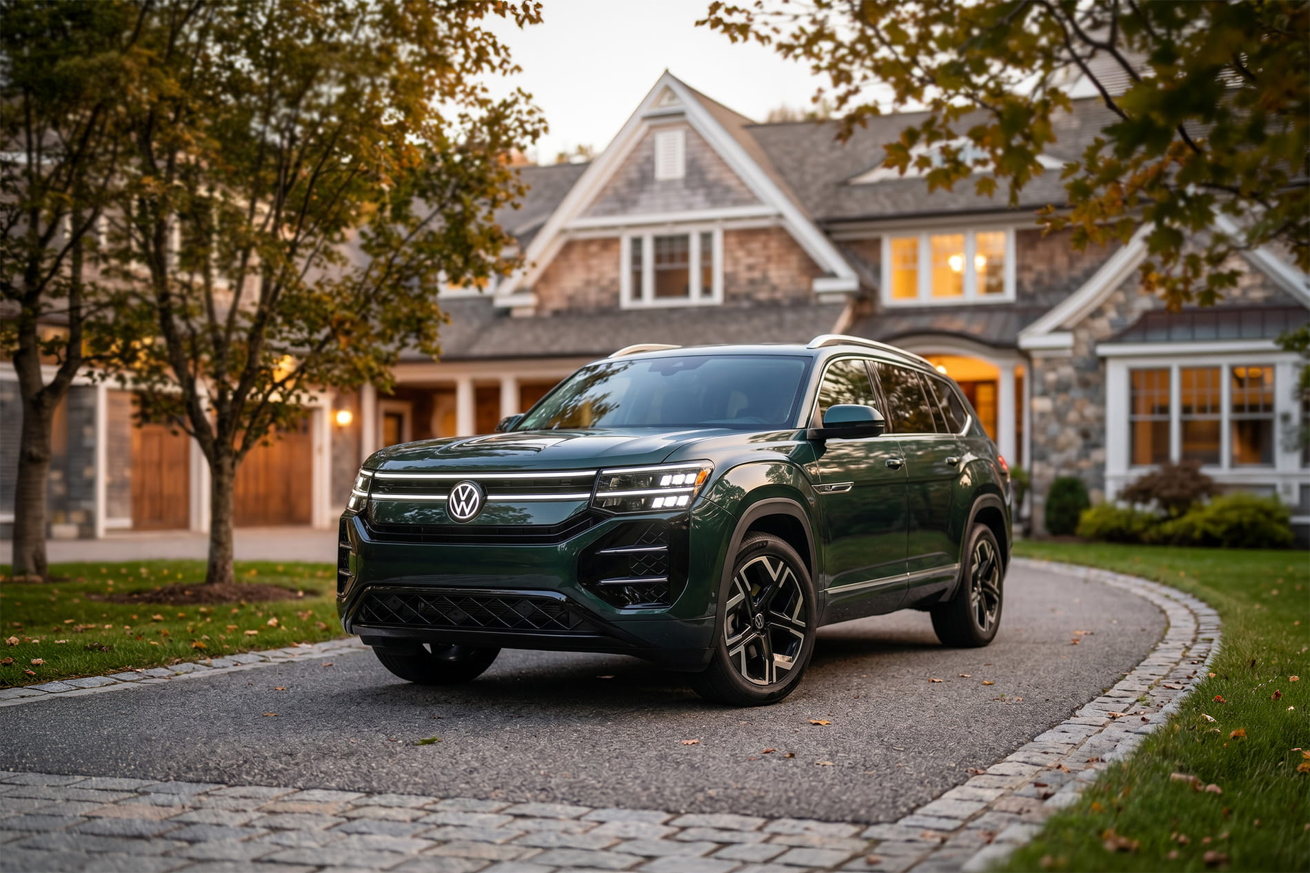 2027 Volkswagen Atlas parked in the driveway of a large brick home
