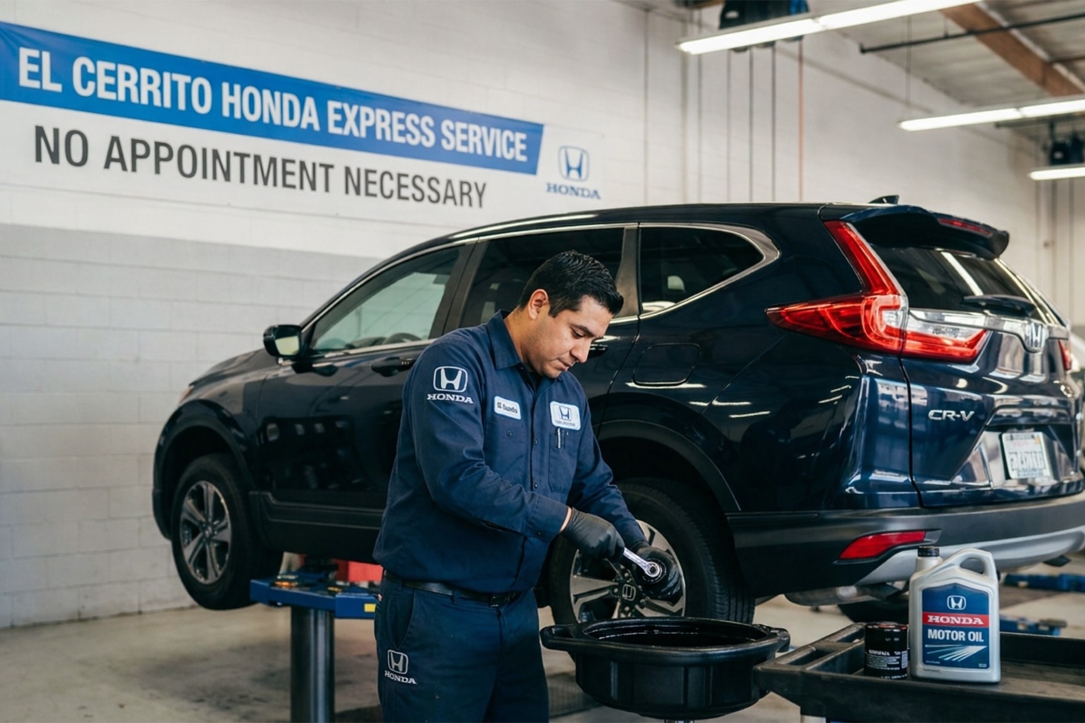 A man in the El Cerrito Honda Service Center near Oakland is changing oil on a blue Honda CR-V