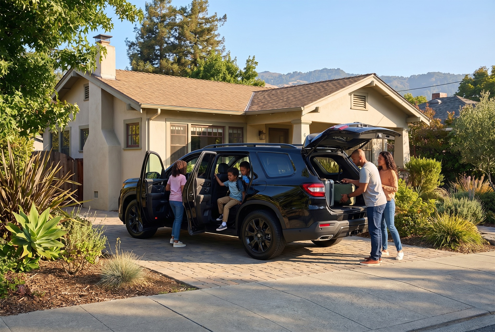 2026 Honda Pilot parked in a suburban driveway with doors open as a family loads luggage, with children entering the vehicle and mountains visible behind the home.