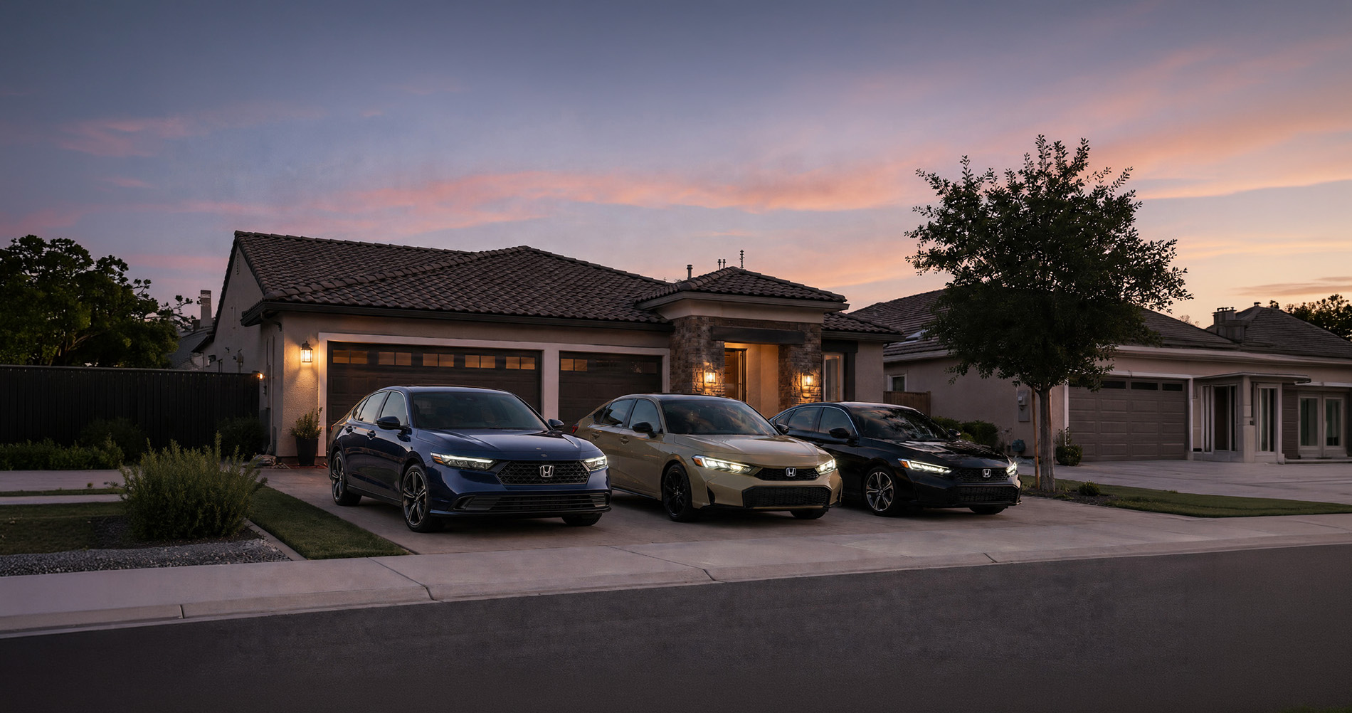 Three 2026 Honda sedans in blue, beige, and black parked side by side in a residential driveway at sunset, with warm porch lights illuminating a modern single-story home in Tracy, California, showcasing the Accord and Civic trim variations in a suburban setting.