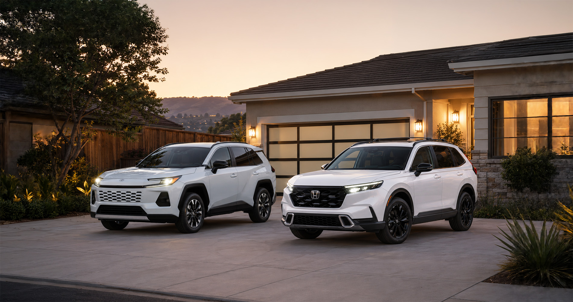 Two white SUVs—a 2026 Honda CR-V and a 2026 Toyota RAV4—parked side by side in a residential driveway at sunset in El Cerrito, California, with modern homes and soft lighting in the background, showcasing their sleek styling and hybrid efficiency.