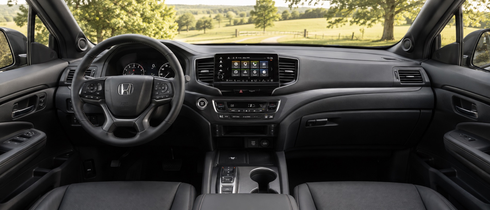2026 Honda Ridgeline interior with leather seating and a Central Kentucky road scene visible through the windows.