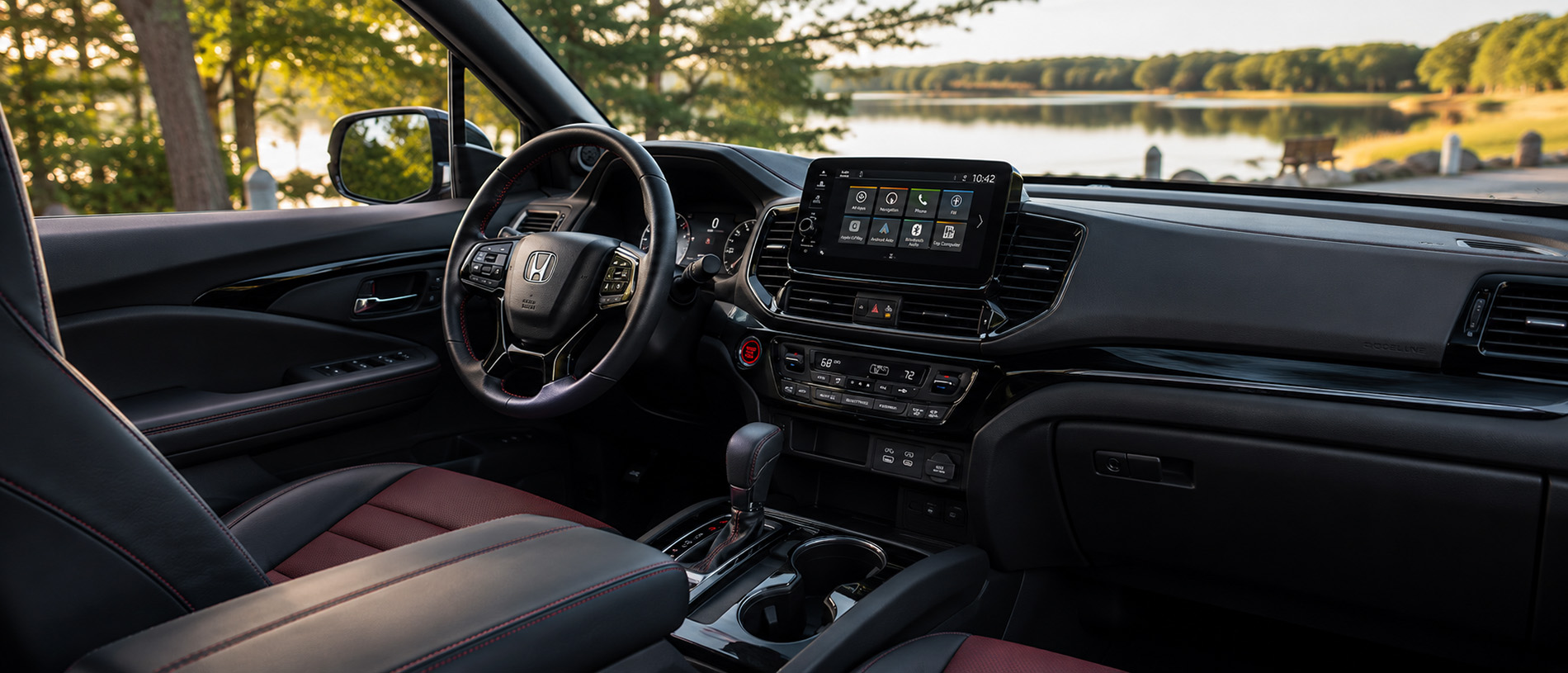 2026 Honda Ridgeline Black Edition interior view with a scenic lake through the windows.