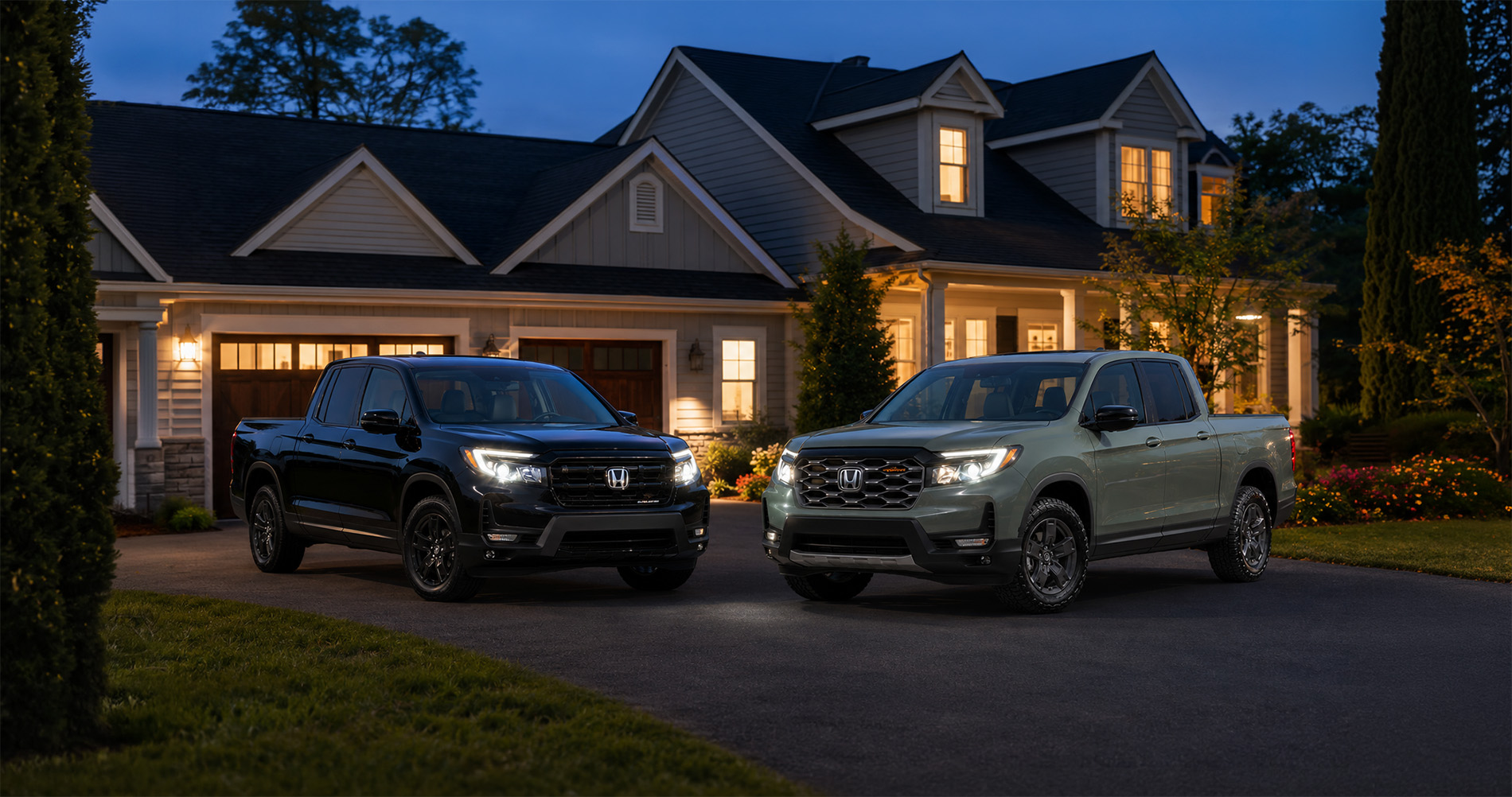 2026 Honda Ridgeline models parked in the driveway of a nice home.