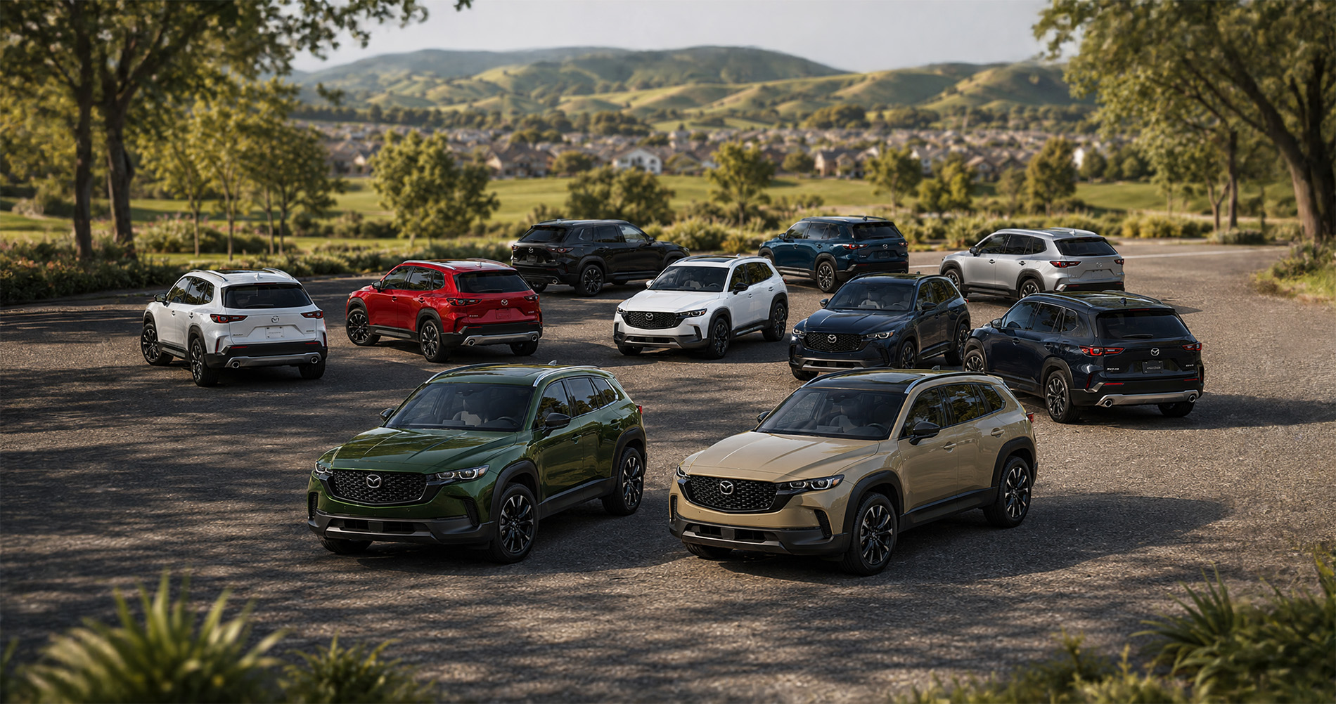Ten CX‑50 SUVs in various colors parked outdoors with hills and homes in the background.