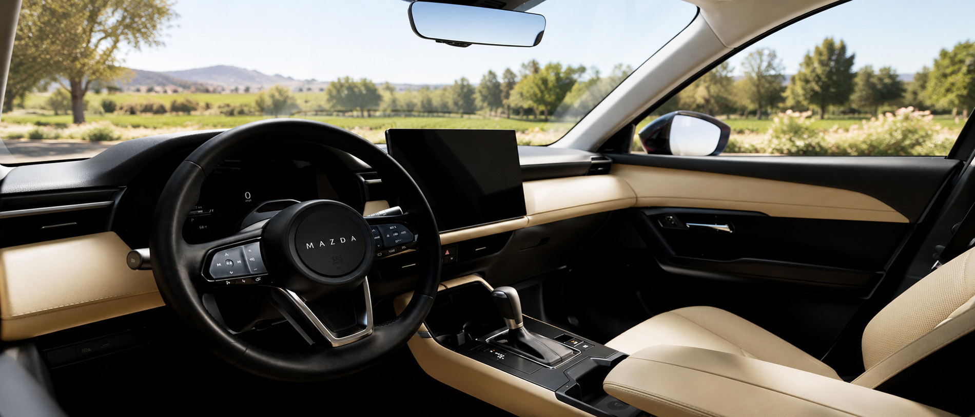 View of the 2026 Mazda CX-5 interior with a beige and black cabin with digital display and clean dashboard design, highlighting comfort and craftsmanship.  