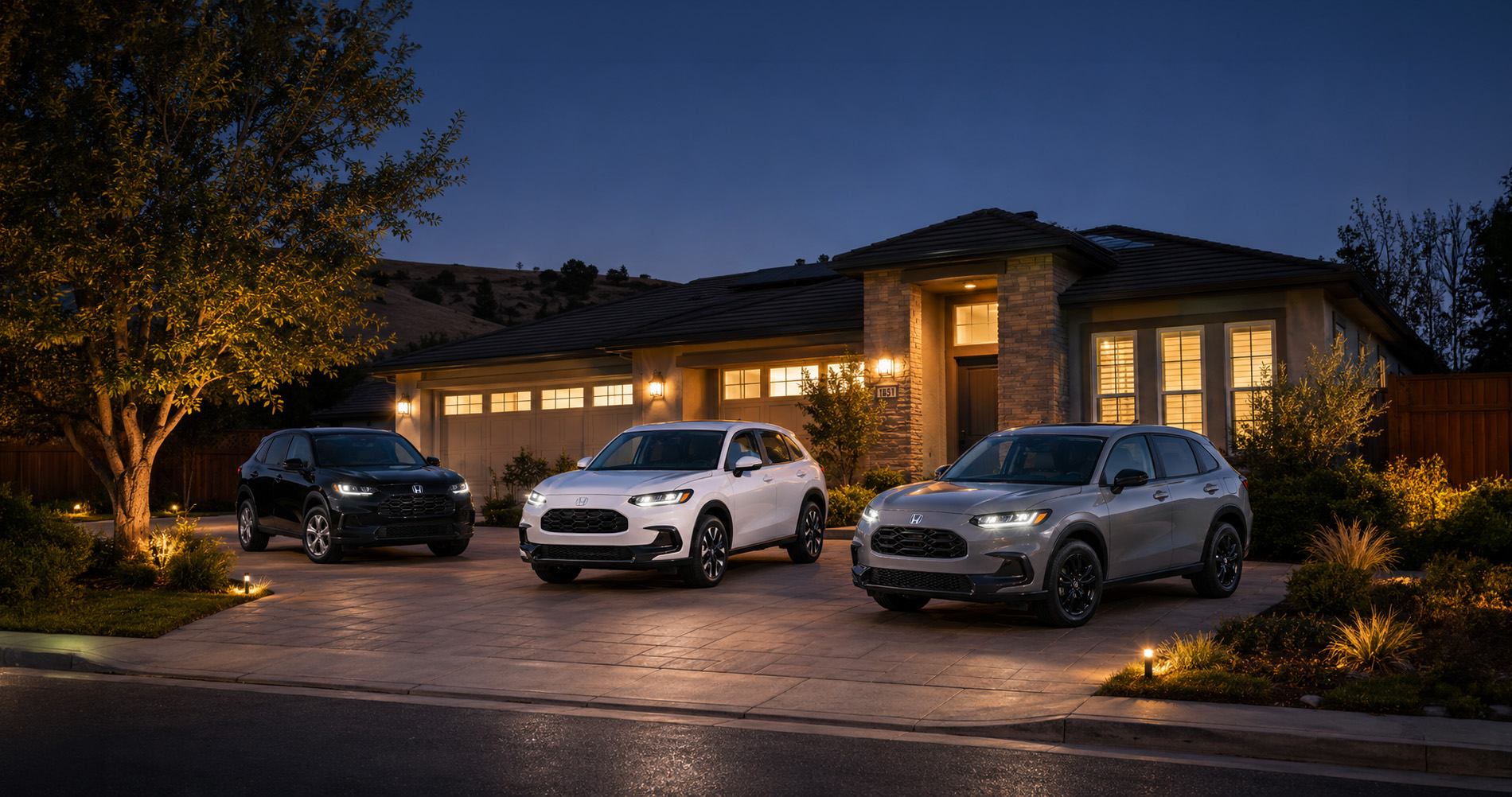     Three 2027 Honda HR-V SUVs parked in a residential driveway at dusk.
