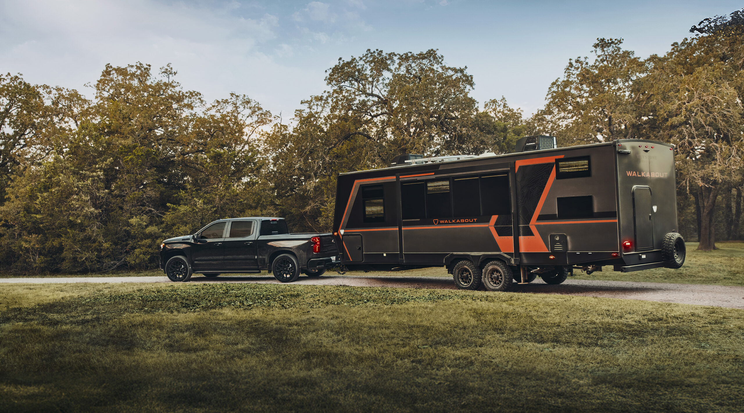 2026 Chevrolet Silverado 1500 Crew Cab High Country Midnight Black Edition towing an RV.