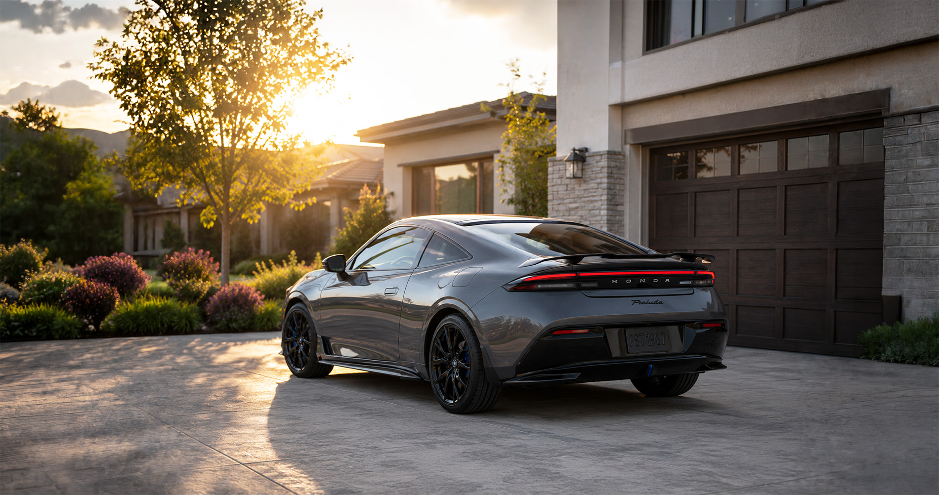 Gray Prelude parked in driveway at sunset, showcasing sleek coupe styling and aerodynamic rear profile.