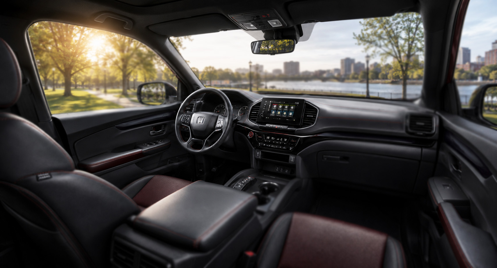 Black and red Honda Ridgeline cabin with touchscreen display and leather seats highlighting comfort and modern design.