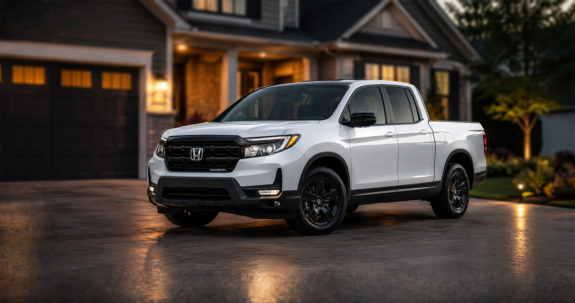 White 2026 Honda Ridgeline Black Edition Two-Tone parked in a driveway at dusk with black wheels and a contrasting black roof.