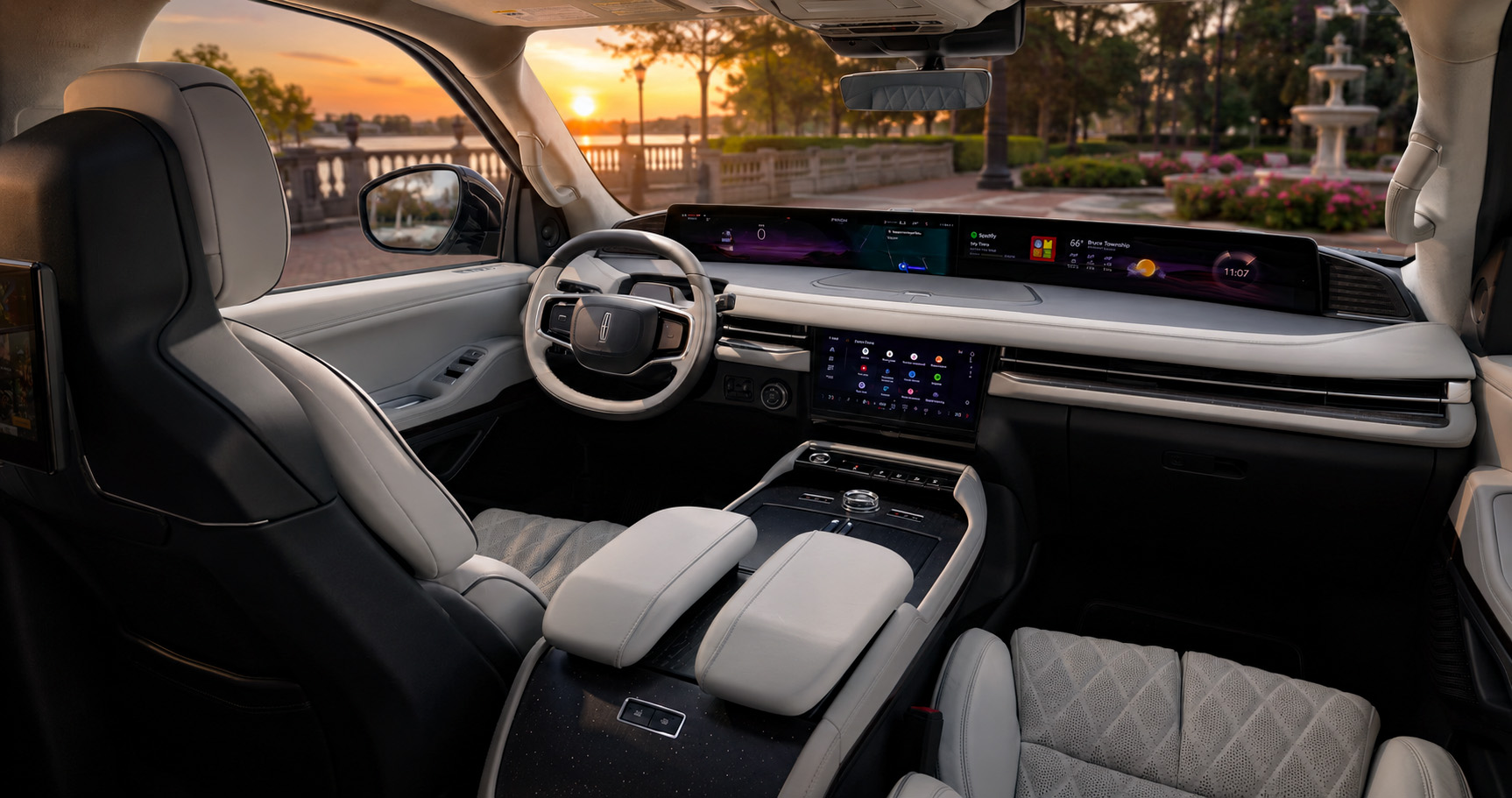 Light gray Lincoln Navigator cabin with quilted leather seats and panoramic digital dashboard overlooking fountain and waterfront at sunset.