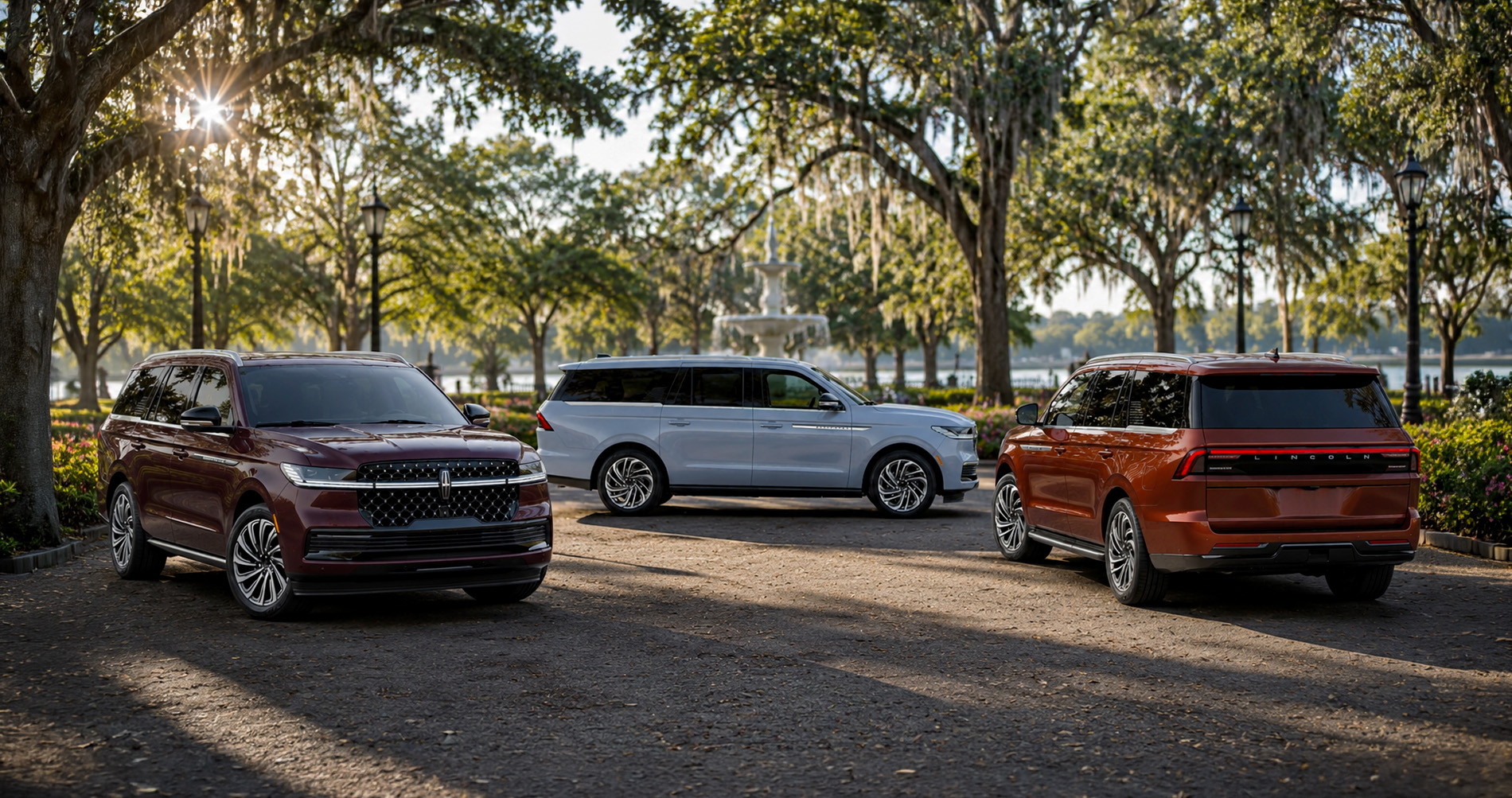 2027 Lincoln Navigator Premiere Reserve and Black Label trim levels parked near fountain under moss-draped trees showcasing full trim range.