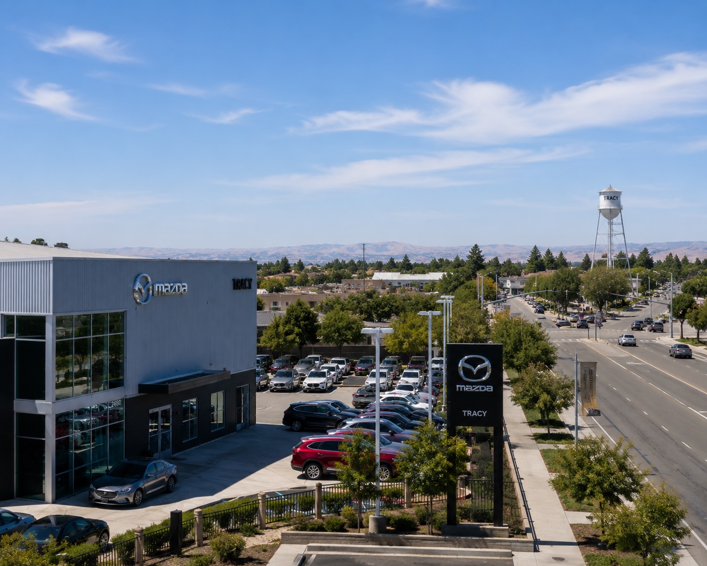 Tracy Mazda dealership in Tracy, CA with the Tracy water tower in the background, representing local Mazda finance and lease shopping