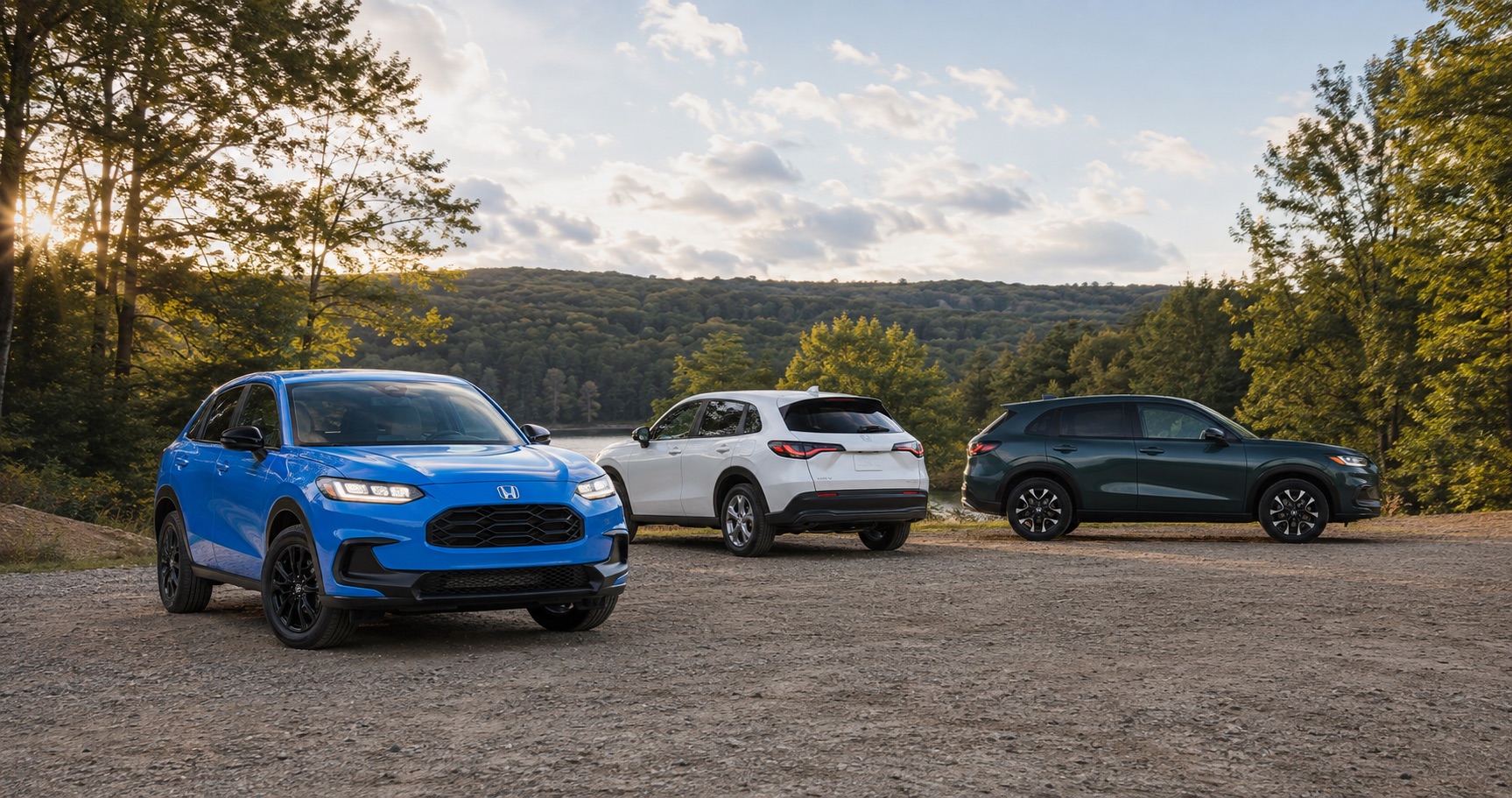 Three Honda HR‑V SUVs in blue white and green parked near lake at sunset showcasing full trim range and color options.