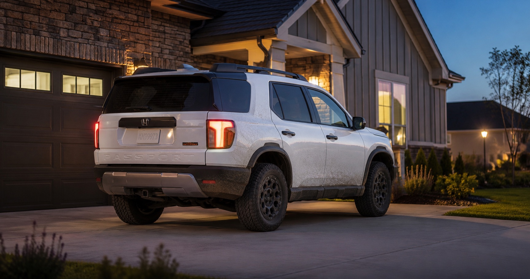 White Honda Passport TrailSport parked in driveway at dusk in front of modern home highlighting rugged styling and LED taillights.