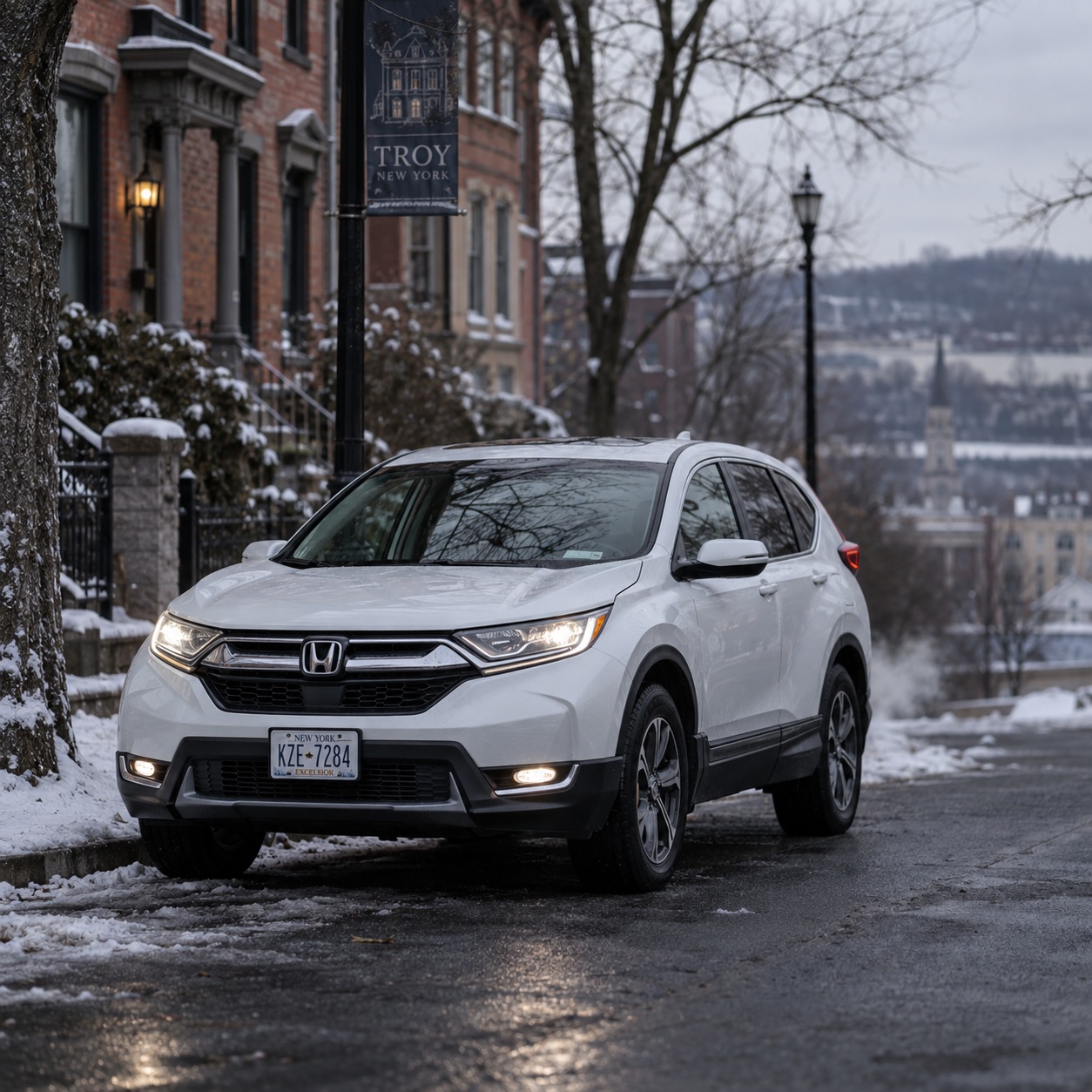 White 2020 Honda CR-V EX-L parked on a snowy street in Troy, NY on a cold winter morning.