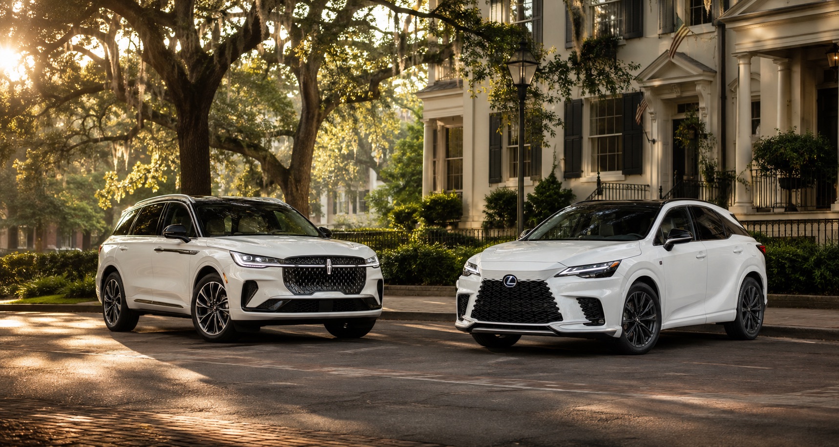 Two white luxury SUVs, Lincoln Nautilus and Lexus RX, parked side by side on a quiet street lined with trees and classic southern architecture.