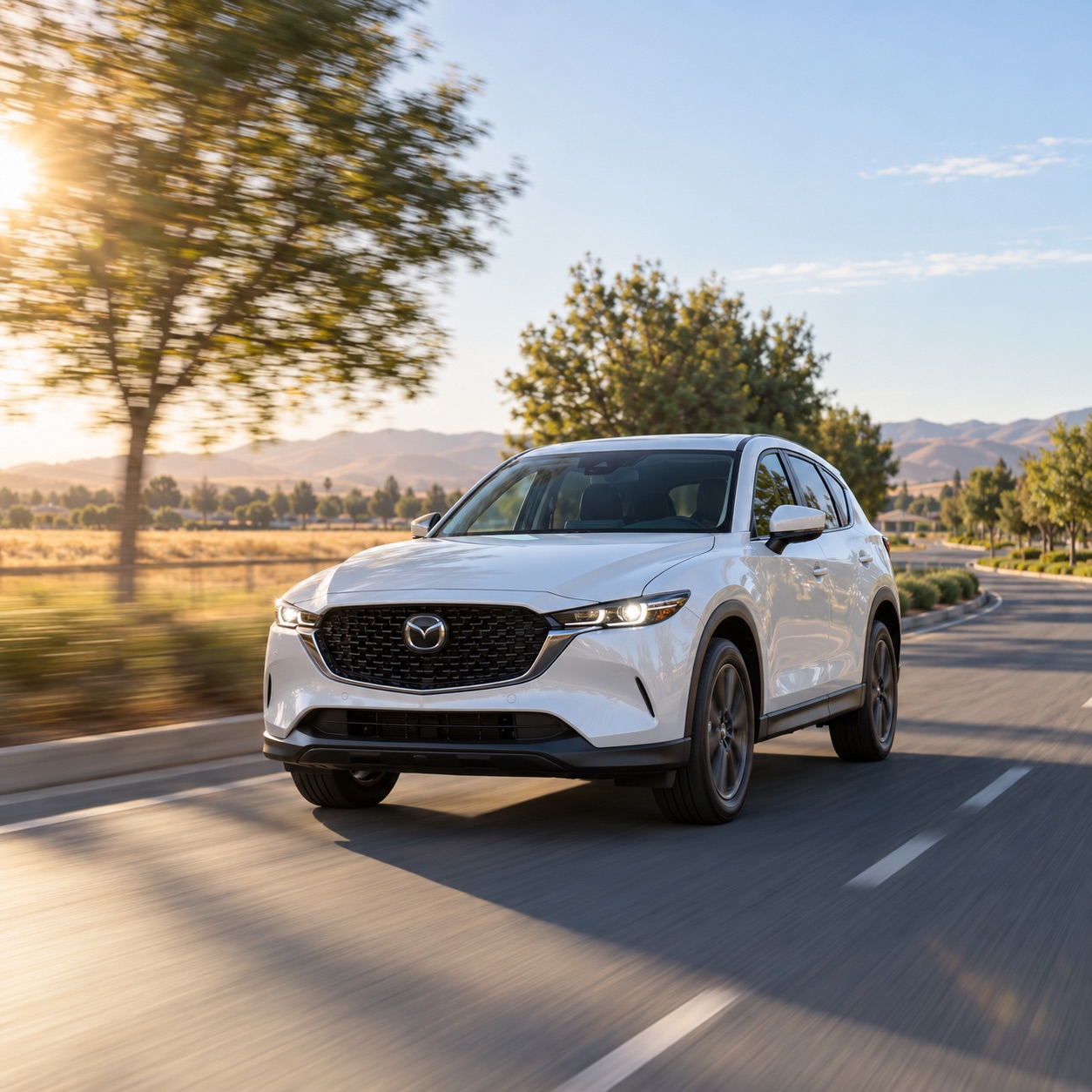 White 2026 Mazda CX-5 driving through a suburban-edge road in Tracy, California, with dry summer grasses and rolling hills in the background