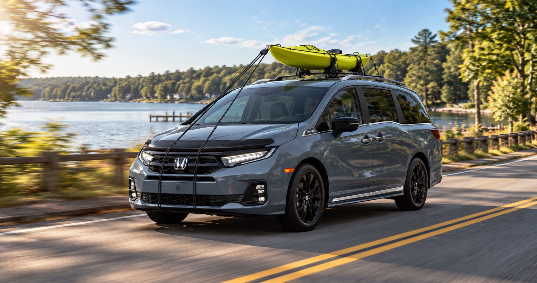 2027 Honda Odyssey Sport-L driving near a lake in Raynham, MA with a kayak on the roof