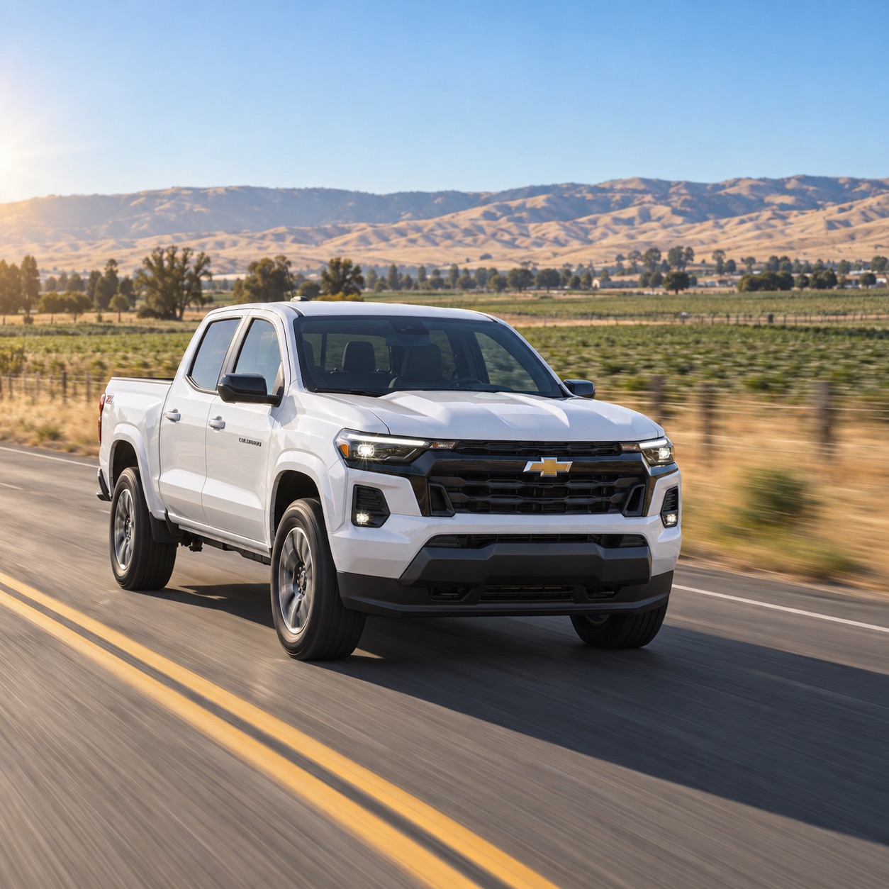 White 2026 Chevrolet Colorado driving through the agricultural landscape near Tracy California