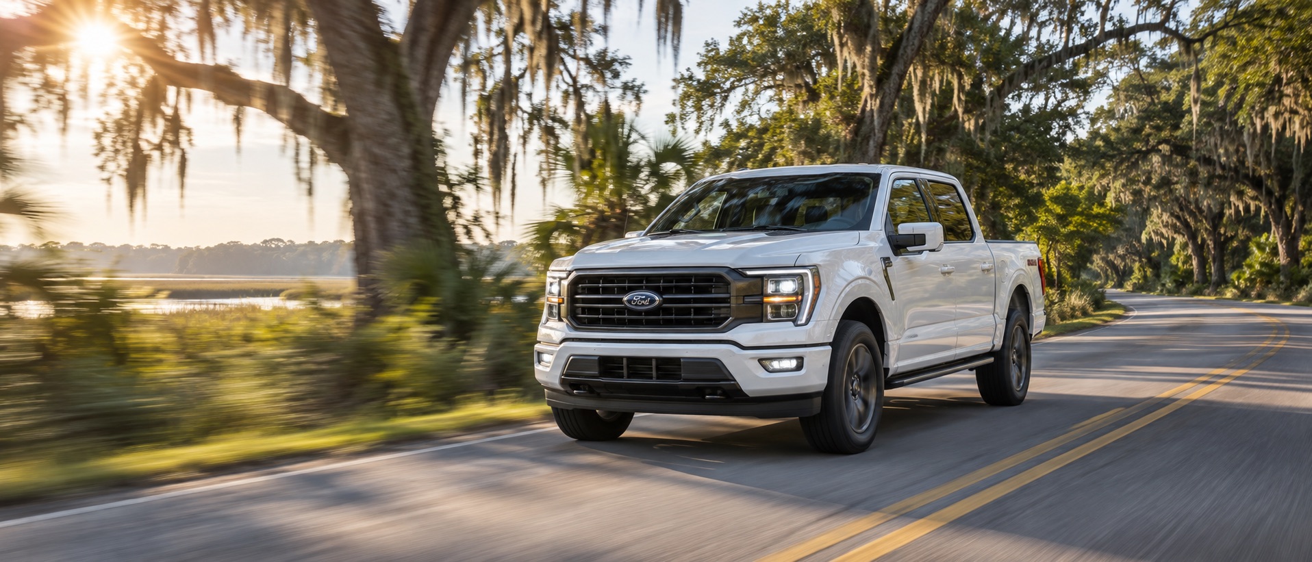 White 2026 Ford F-150 driving past live oaks and Lowcountry marsh near Bluffton, South Carolina