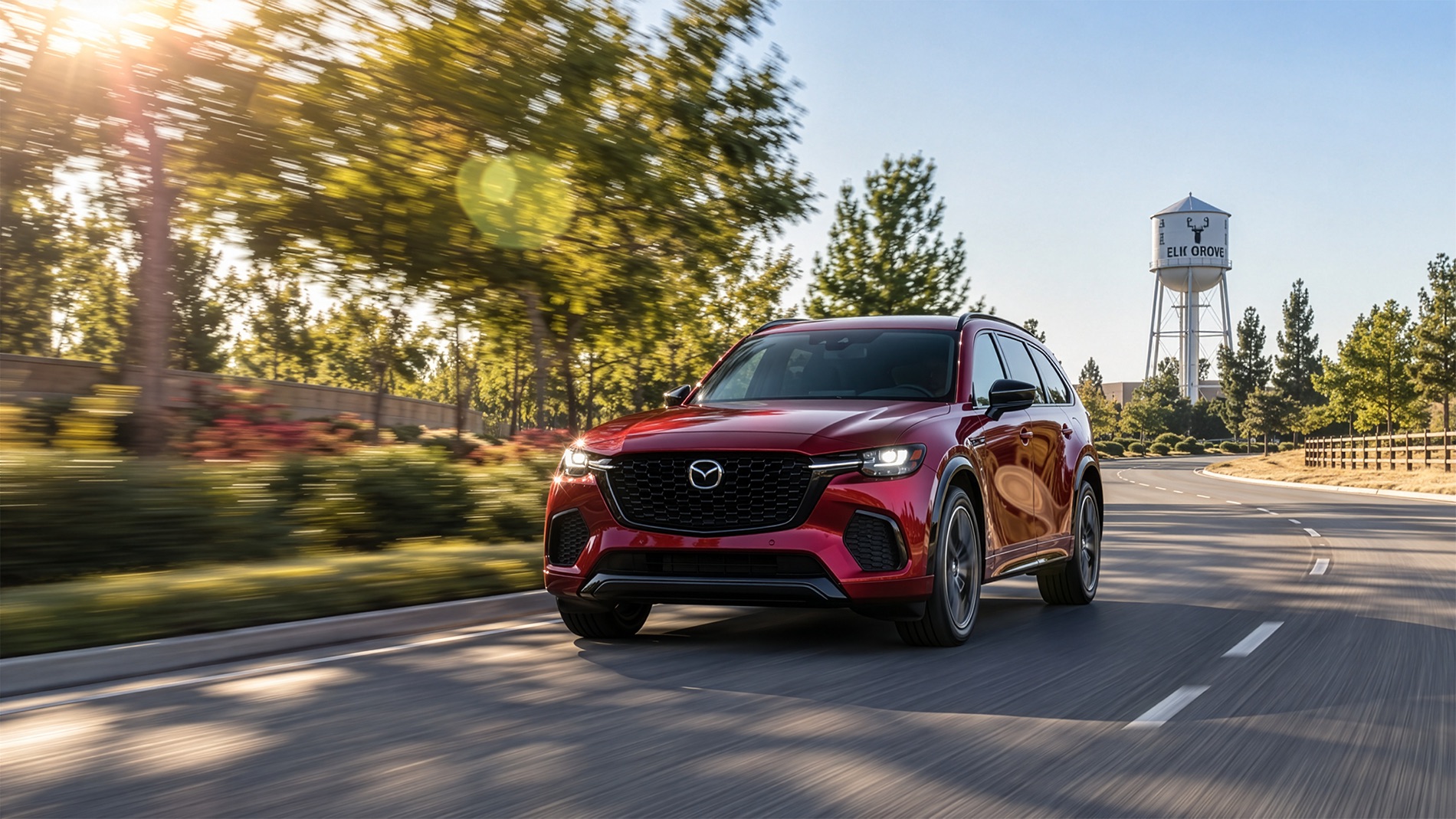 2026 Mazda CX-70 in Soul Red Crystal driving through Elk Grove, CA on a clear summer morning