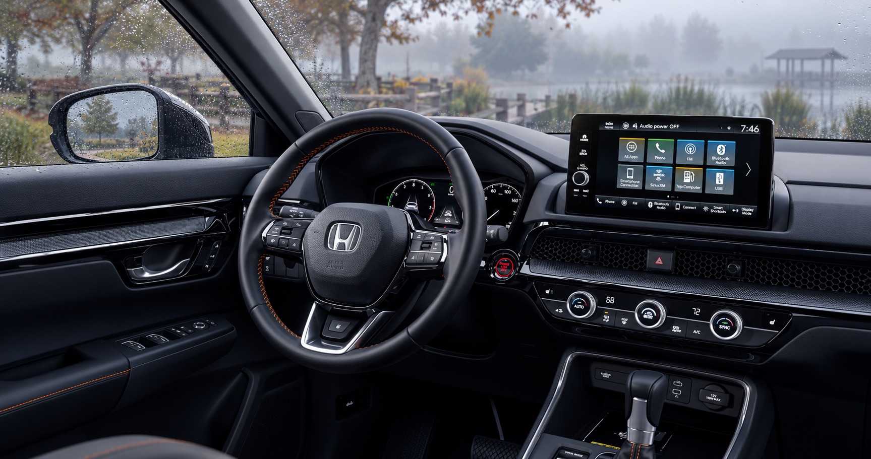 2027 Honda CR-V TrailSport Hybrid black interior with orange stitching overlooking a rainy park in Tracy, CA