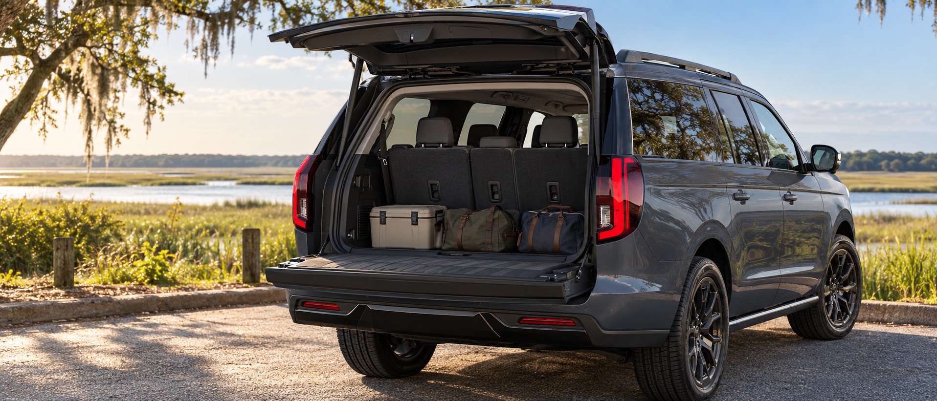 Rear cargo area of a 2027 Ford Expedition MAX with its split tailgate open at a tidal marsh overlook near Savannah, Georgia