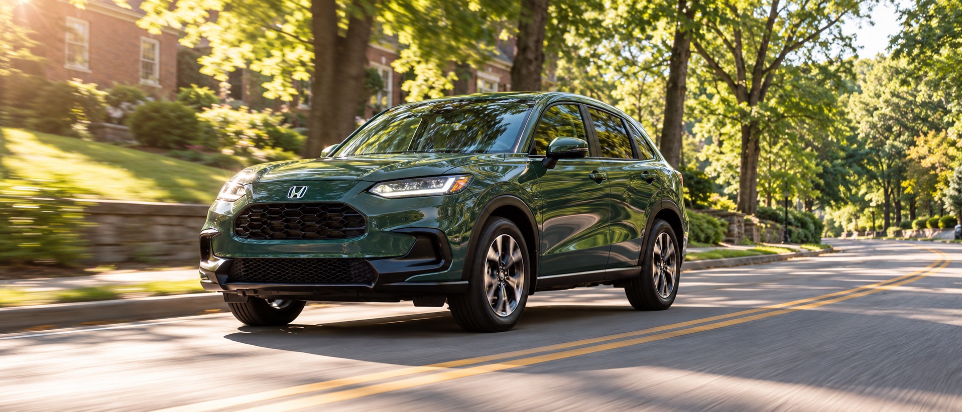 Green 2027 Honda HR-V EX-L AWD driving on a sunlit, tree-lined residential road in Troy, New York