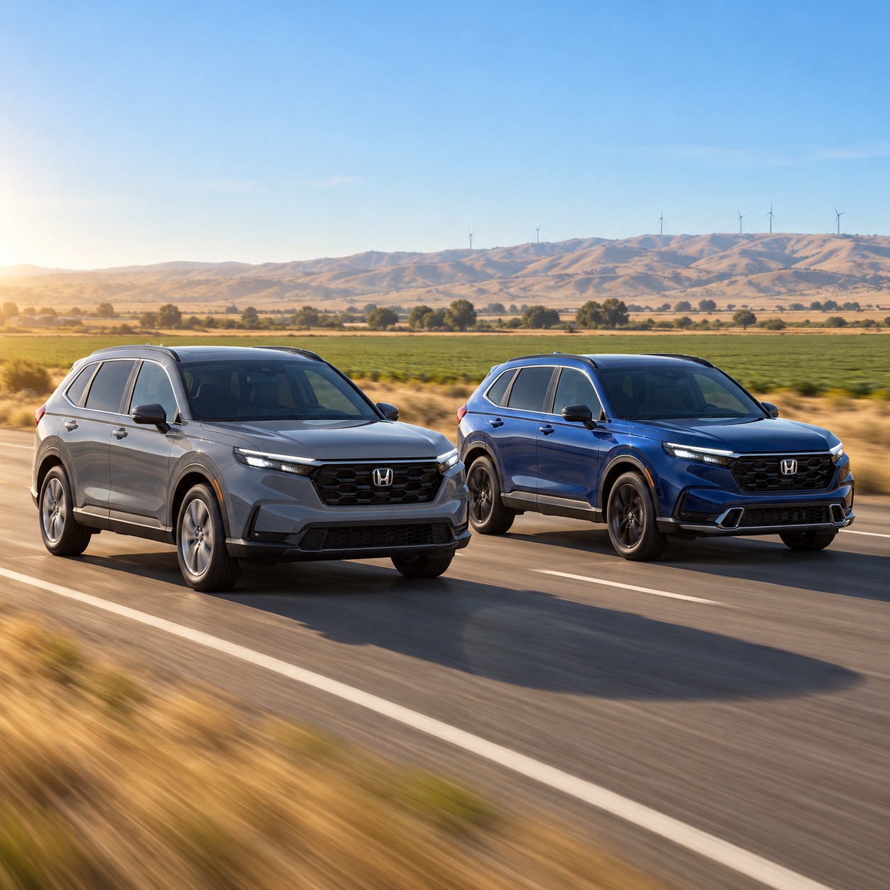 Two 2027 Honda CR-V SUVs, an Urban Gray Pearl CR-V EX and a Canyon River Blue Metallic CR-V Sport Touring Hybrid, driving through farmland near Tracy, California, with dry Altamont foothills and distant wind turbines in the background.
